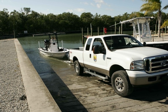 two, employees, pickup truck, boat, water, boat, ramp