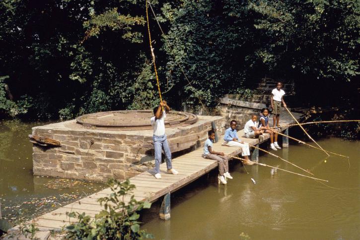 Afro American kids, fishing, wooden, bridge